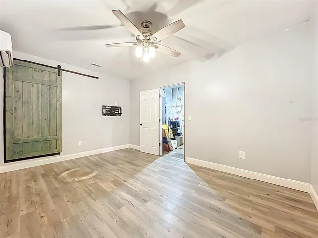 a view of a chair and tables in the patio next to a yard