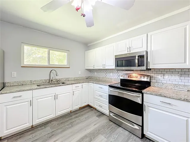 a view of a tall building with large trees