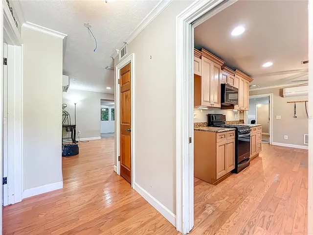 a kitchen with granite countertop a sink a counter top space stainless steel appliances and cabinets