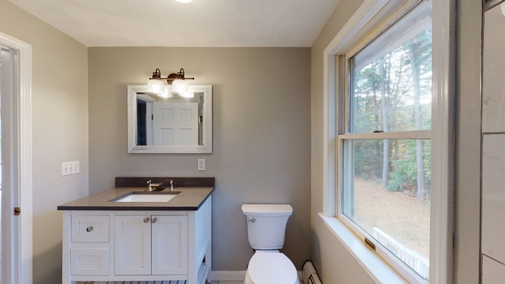 7 Nehemiah Road Shirley, MA 01464 - Photo 28 of 37 a bathroom with a toilet a sink and a mirror