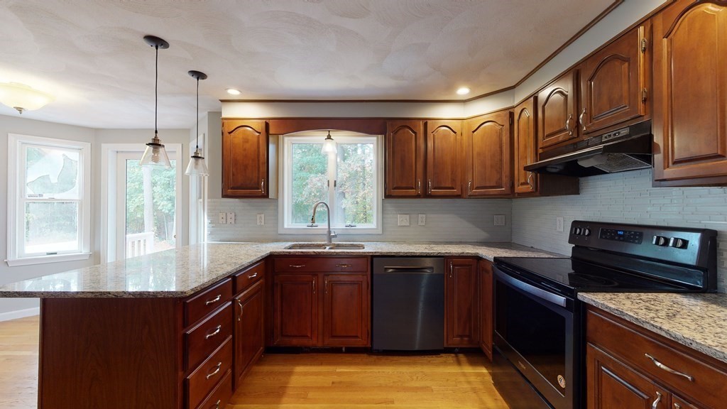 7 Nehemiah Road Shirley, MA 01464 - Photo 7 of 37 a kitchen with stainless steel appliances granite countertop a sink stove and cabinets
