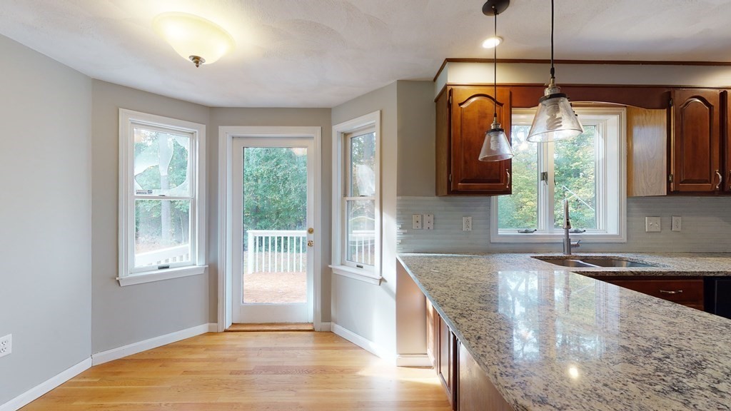 7 Nehemiah Road Shirley, MA 01464 - Photo 10 of 37 a kitchen with stainless steel appliances granite countertop a sink a window and wooden floor