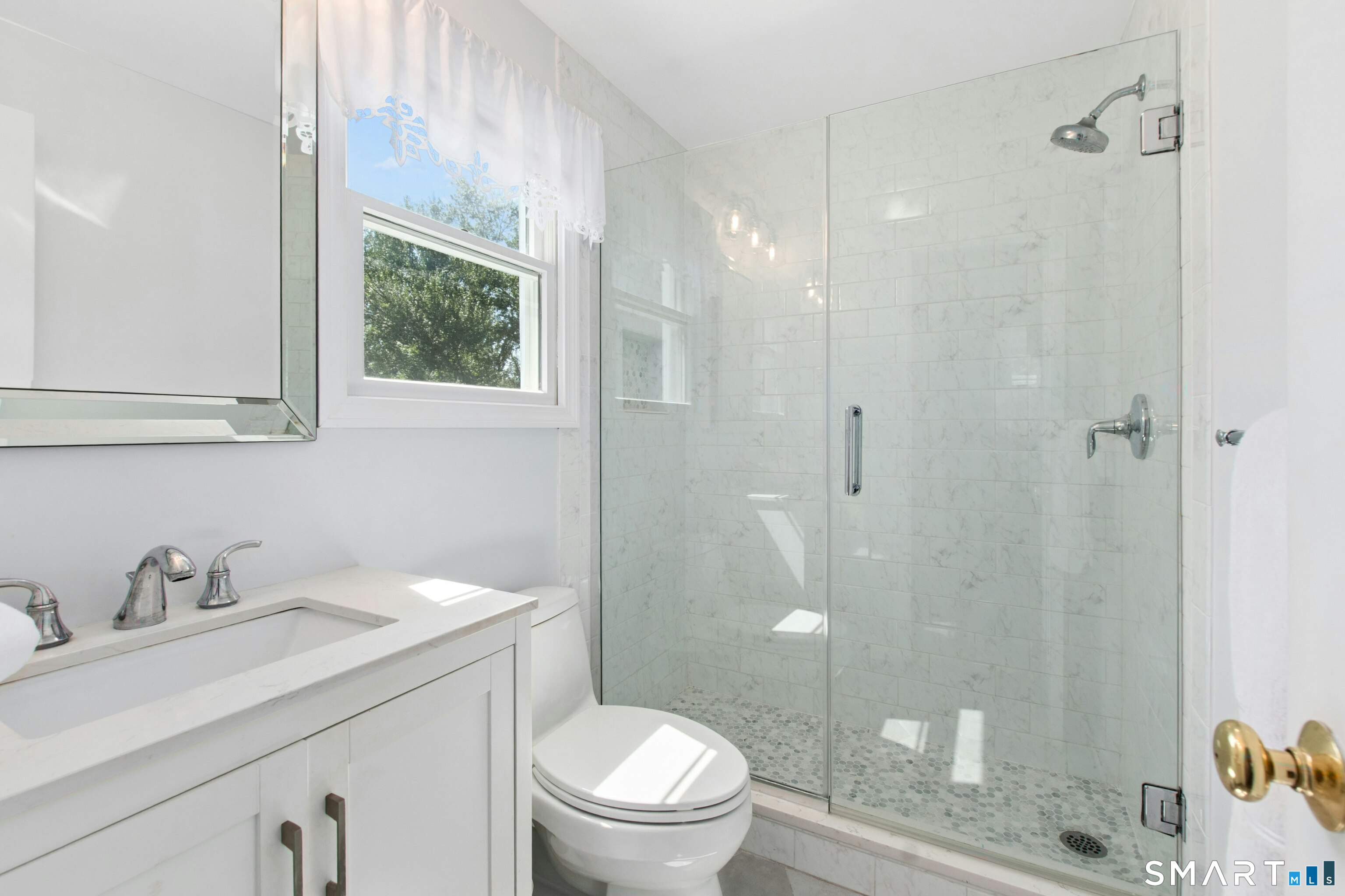 47 Pine Ridge Road Wilton, CT 06897 - Photo 35 of 40 The Primary En-Suite Bathroom has a modern, efficient design. Though boutique in scale, it features a complete luxury update with high-end tilework, premium fixtures, and a crisp, clean aesthetic that maximizes every square inch.