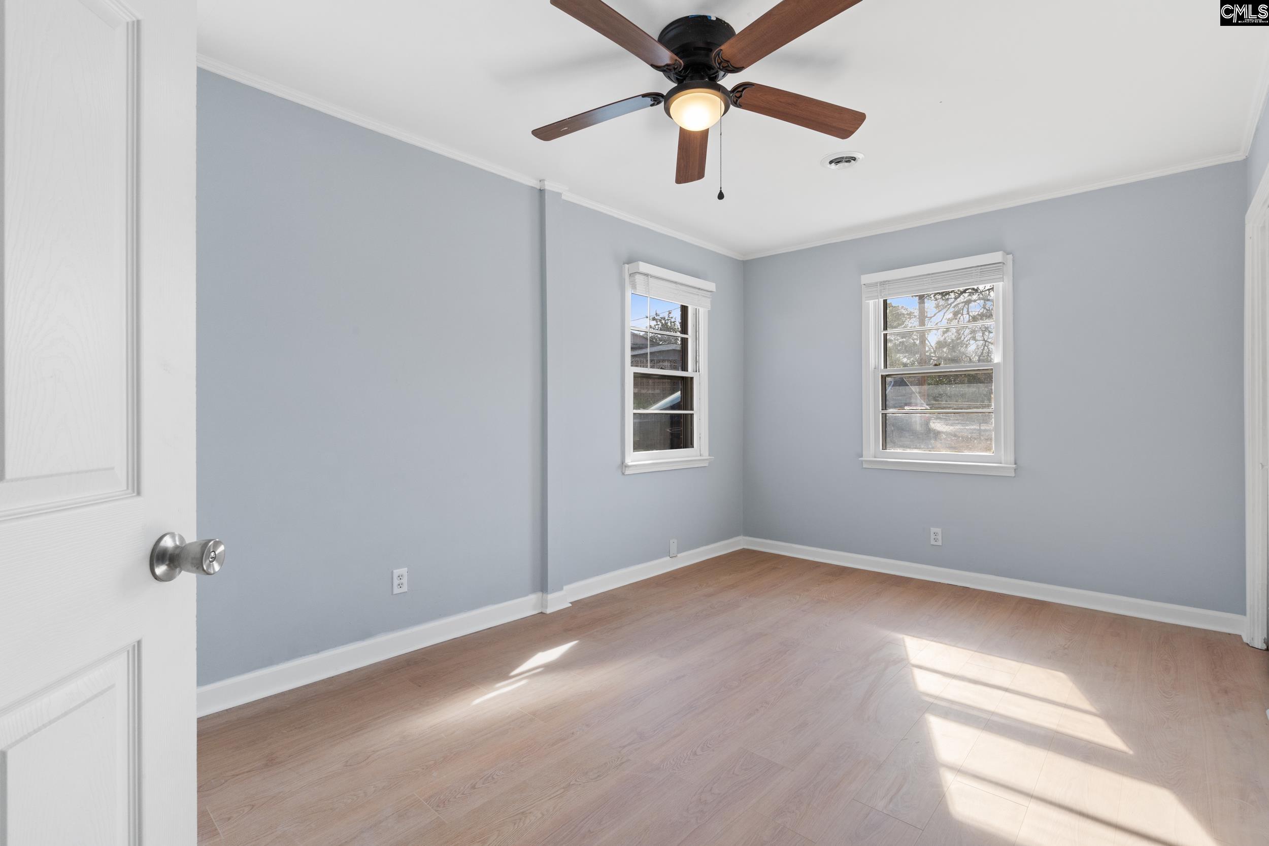 409 Wilkes Road Columbia, SC 29203 - Photo 21 of 34 an empty room with windows and fan