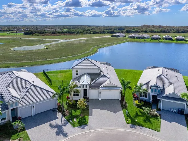an aerial view of a house with a lake view