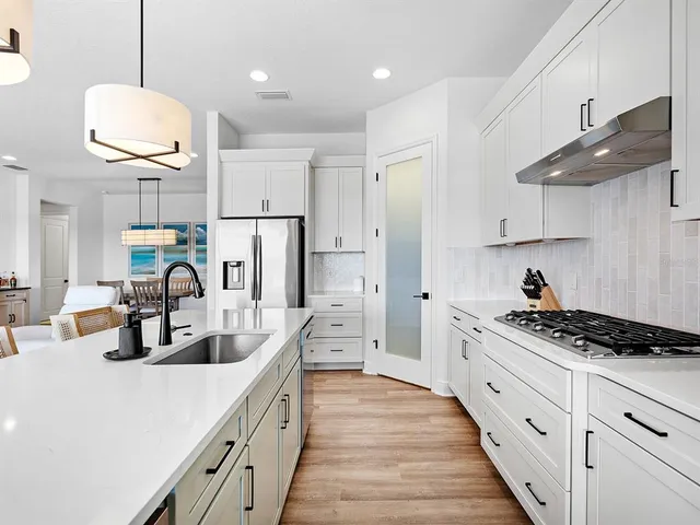 a bathroom with double vanity white cabinets and two mirror