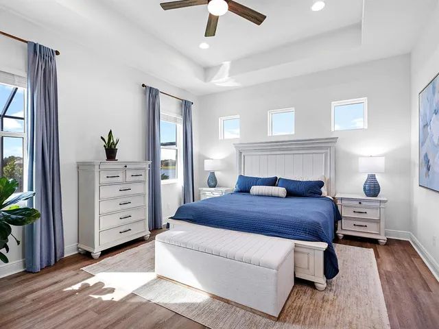 a bedroom with a bed and a painting on the wall