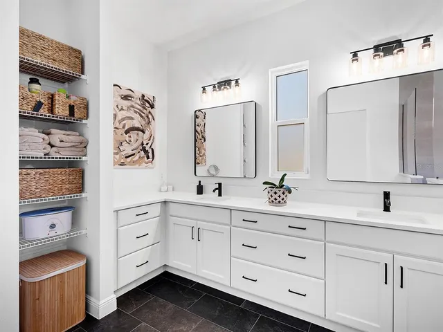 a view of a living room filled with furniture and wooden floor