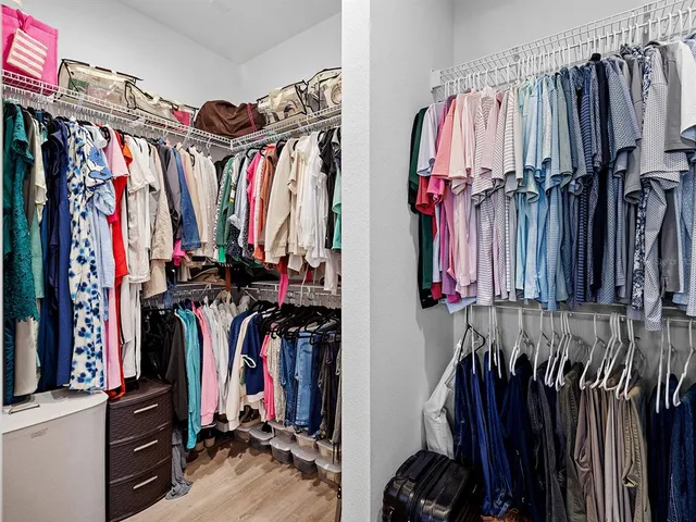 a view of an empty room with window and cabinet