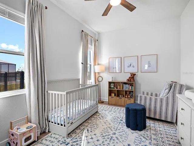 a living room with furniture and a floor to ceiling window