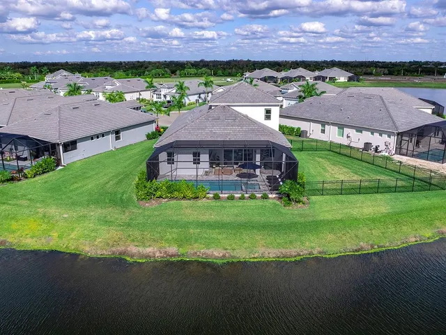 a view of a house with backyard sitting area and a garden