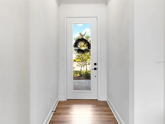a dining room with furniture a chandelier and wooden floor
