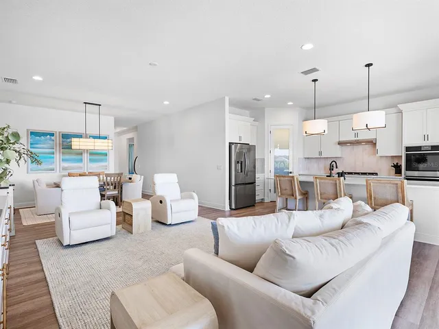 a dining room with furniture a rug and a chandelier