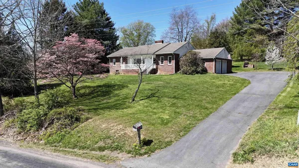 a front view of house with yard and outdoor seating