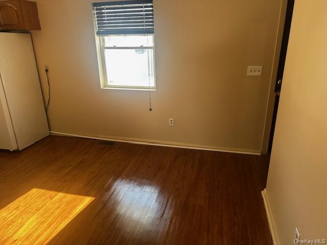 542 Post Avenue Bellport, NY 11713 - Photo 12 of 38 an empty room with wooden floor and windows