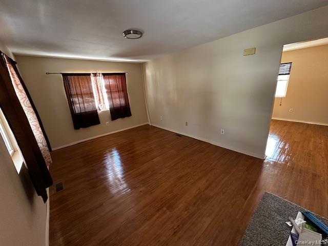 542 Post Avenue Bellport, NY 11713 - Photo 8 of 38 an empty room with wooden floor and windows