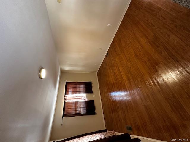 542 Post Avenue Bellport, NY 11713 - Photo 9 of 38 an empty room with wooden floor and windows