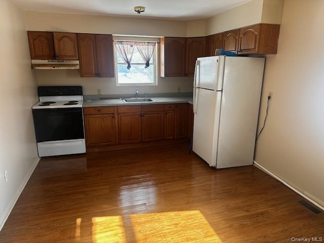 542 Post Avenue Bellport, NY 11713 - Photo 10 of 38 a kitchen with a refrigerator and a stove
