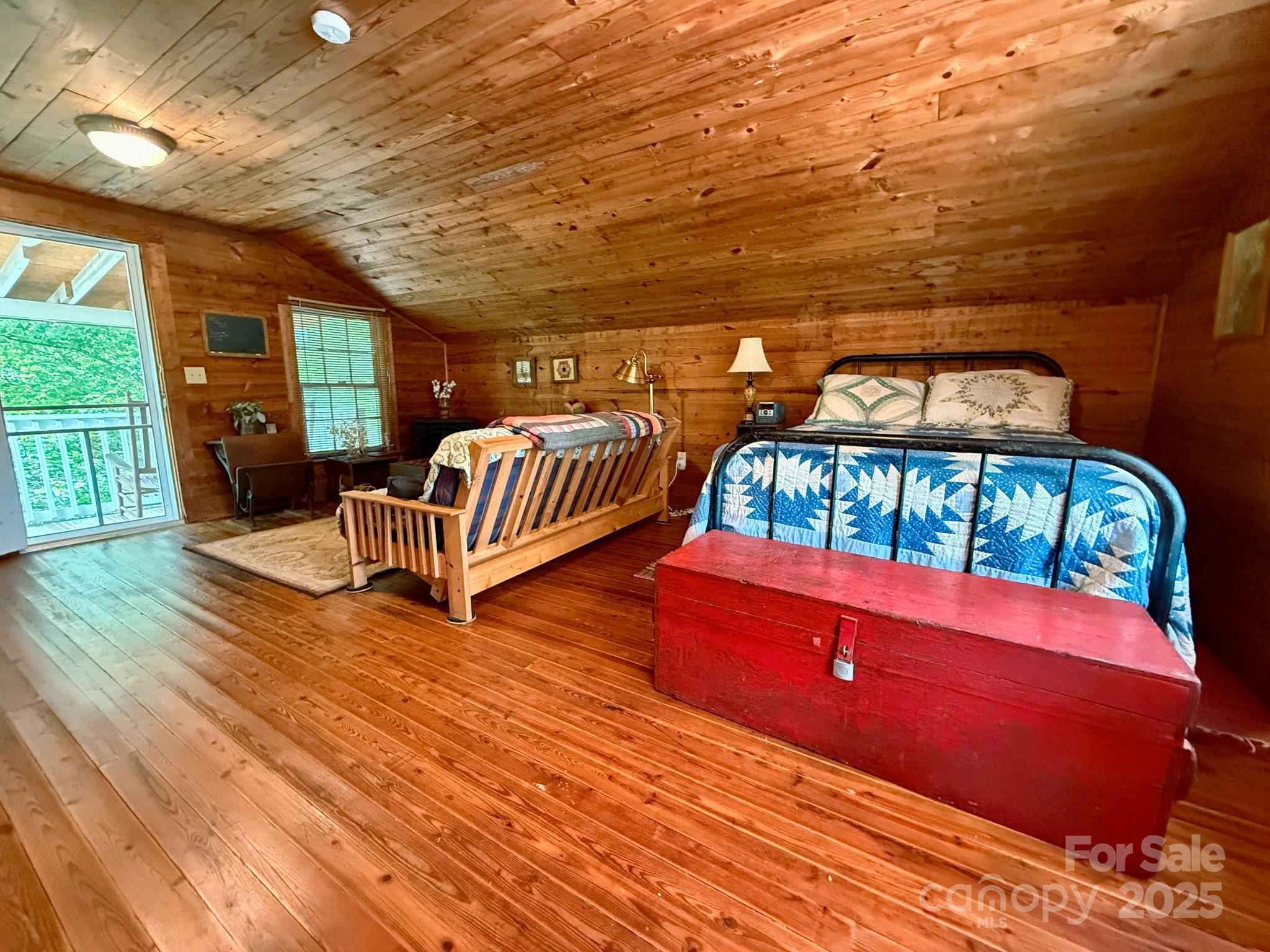1441 Cove Road Rutherfordton, NC 28139 - Photo 30 of 36 a bedroom with furniture and a wooden floor