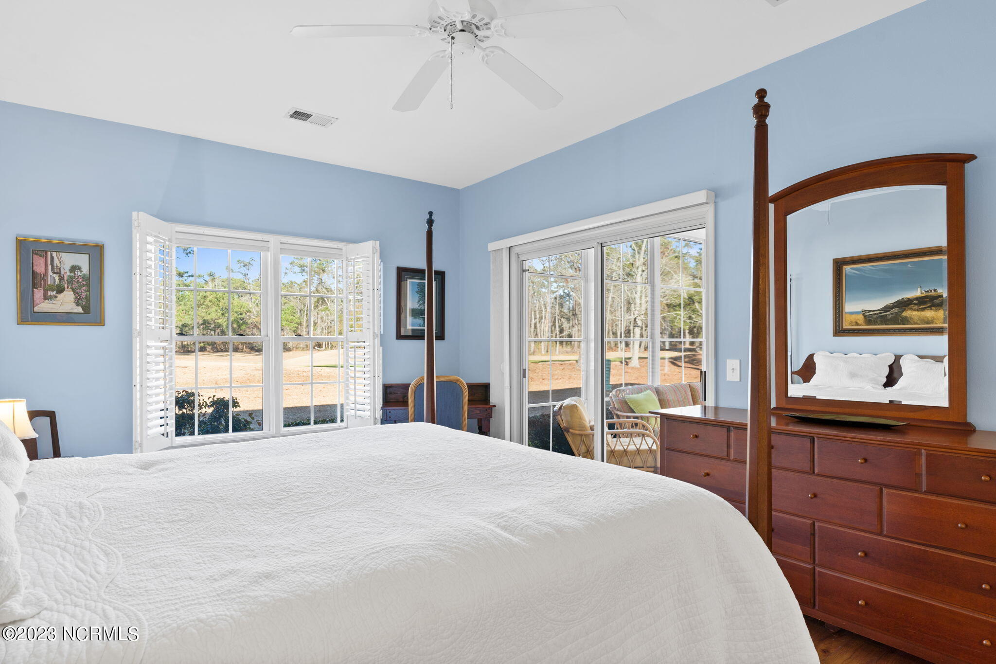 126 Rice Mill Circle, Unit 2 Sunset Beach, NC 28468 - Photo 20 of 90 Primary bedroom with plantation shutters