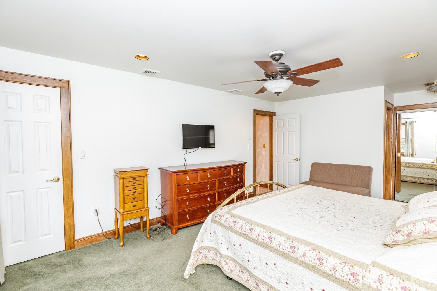 55 Old Post Road Edison, NJ 08817 - Photo 21 of 53 a bedroom with a bed and a chandelier