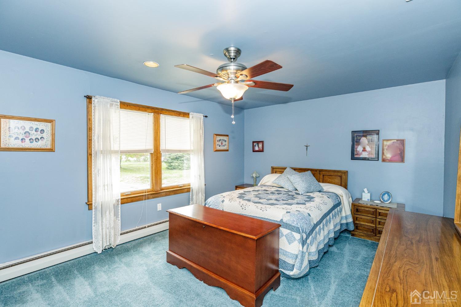 55 Old Post Road Edison, NJ 08817 - Photo 24 of 53 a bedroom with a bed and a chandelier