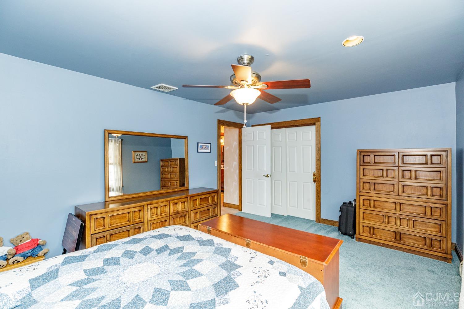 55 Old Post Road Edison, NJ 08817 - Photo 25 of 53 a bedroom with a bed and a chandelier