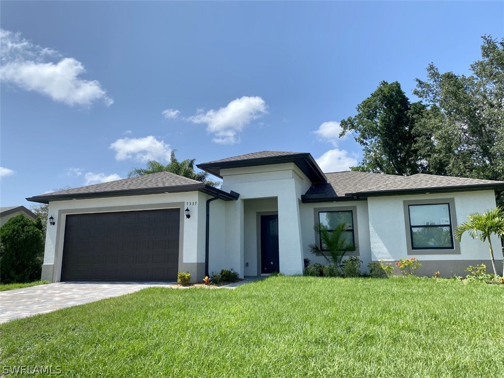 7337 Lobelia Road Fort Myers, FL 33967 - Photo 1 of 21 a front view of a house with a yard and garage