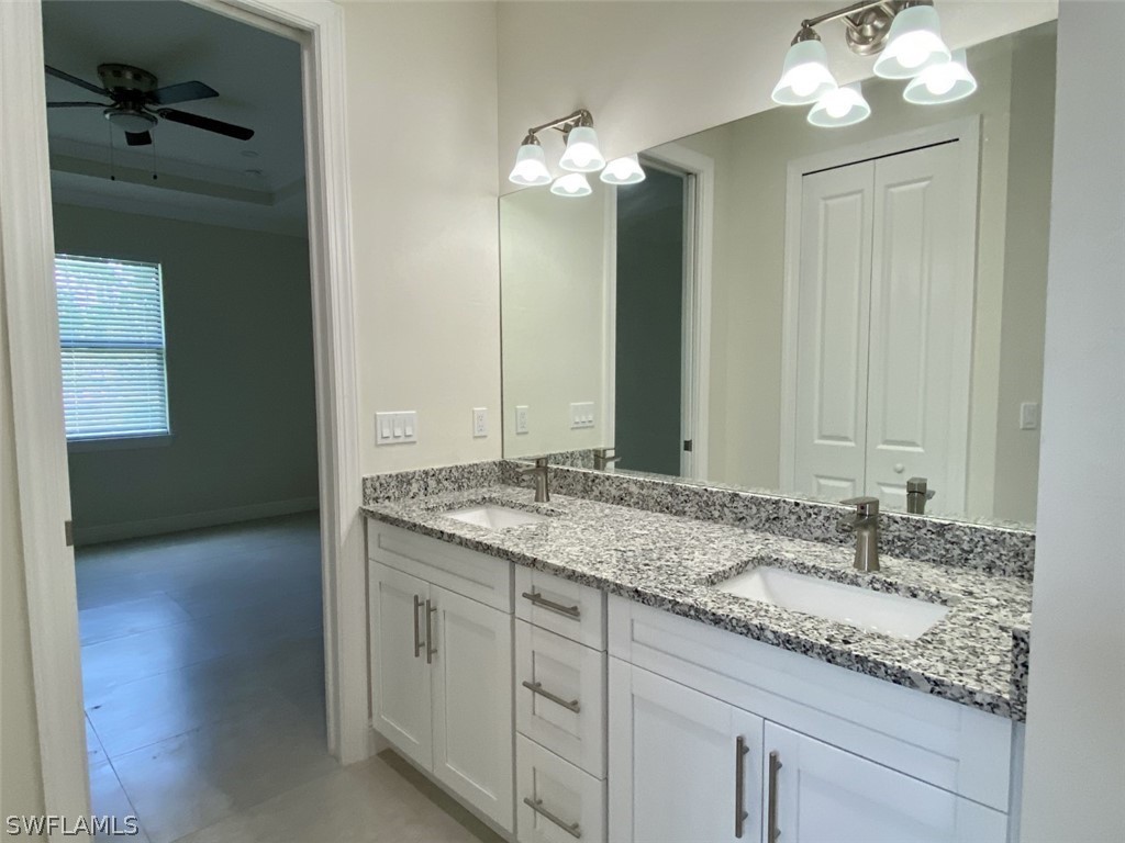 7337 Lobelia Road Fort Myers, FL 33967 - Photo 17 of 21 a bathroom with a granite countertop double vanity sink and a mirror