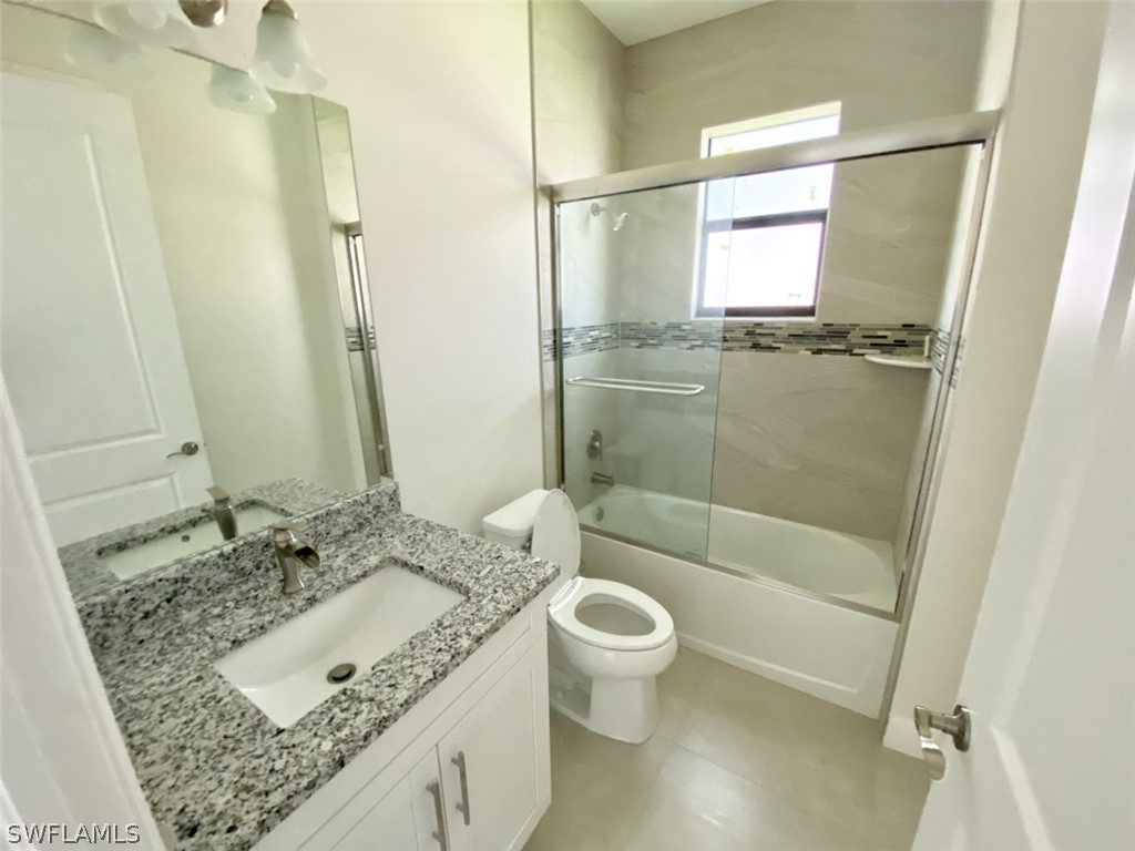 7337 Lobelia Road Fort Myers, FL 33967 - Photo 18 of 21 a bathroom with a granite countertop sink toilet and shower