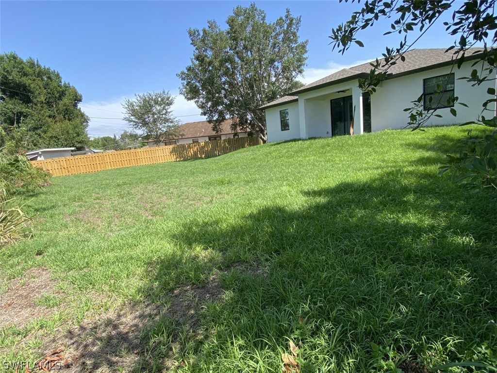 7337 Lobelia Road Fort Myers, FL 33967 - Photo 6 of 21 a view of a house with yard and tree s