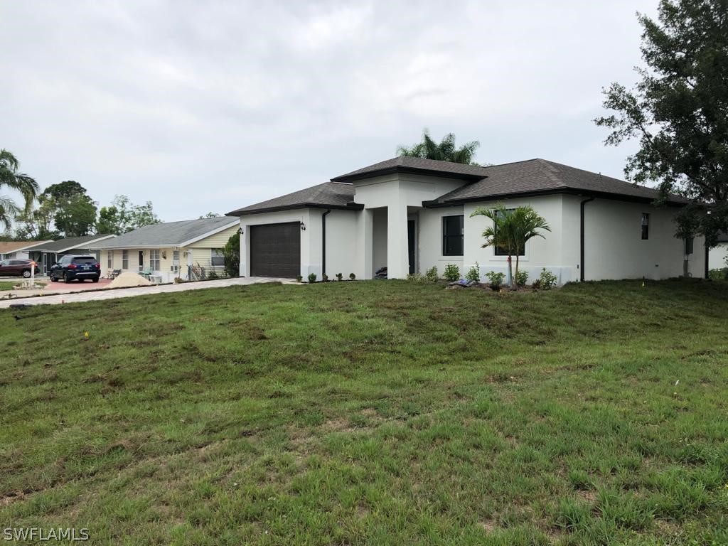 7337 Lobelia Road Fort Myers, FL 33967 - Photo 9 of 21 a front view of a house with a yard