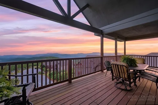 a view of a balcony with furniture and wooden floor