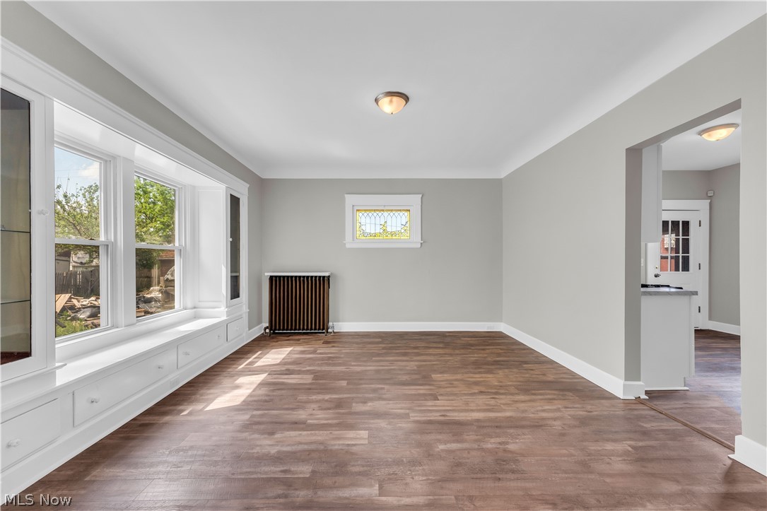 3506 Riverside Avenue Cleveland, OH 44109 - Photo 10 of 31 Spacious room featuring wood-finish flooring, light gray walls, and white crown molding