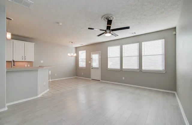 a living room with furniture a table and chairs