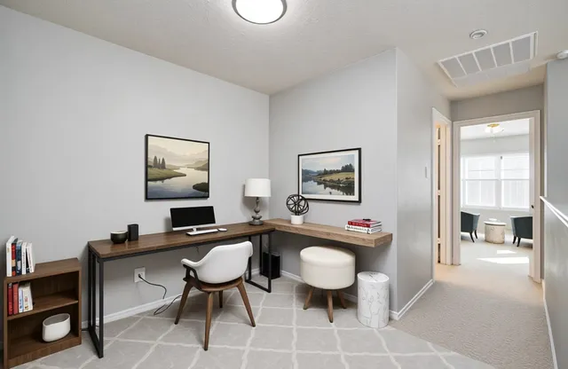 a view of an empty room with a ceiling fan