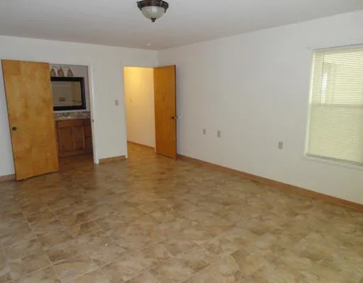a bathroom with a granite countertop sink a mirror and a bathtub