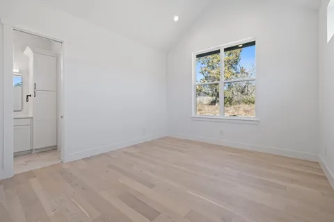 an empty room with windows and closet