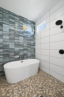 a bathroom with a bathtub and shower