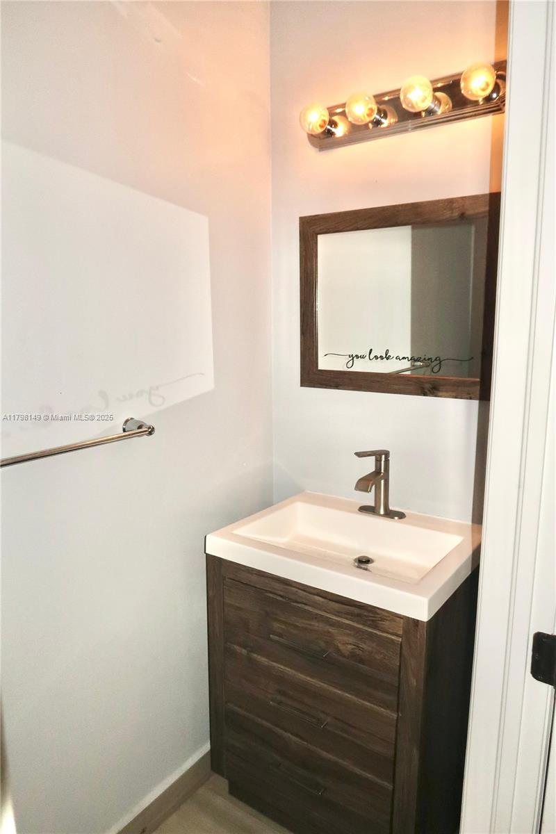 531 Southwest 147th Avenue, Unit 24 Pembroke Pines, FL 33027 - Photo 12 of 16 a bathroom with a sink and a mirror