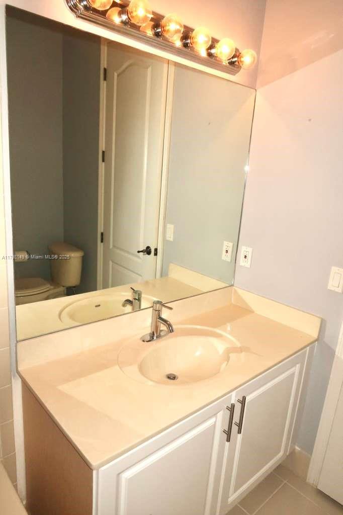 531 Southwest 147th Avenue, Unit 24 Pembroke Pines, FL 33027 - Photo 13 of 16 a bathroom with a sink and a mirror