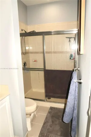 a bathroom with a toilet a sink and a mirror