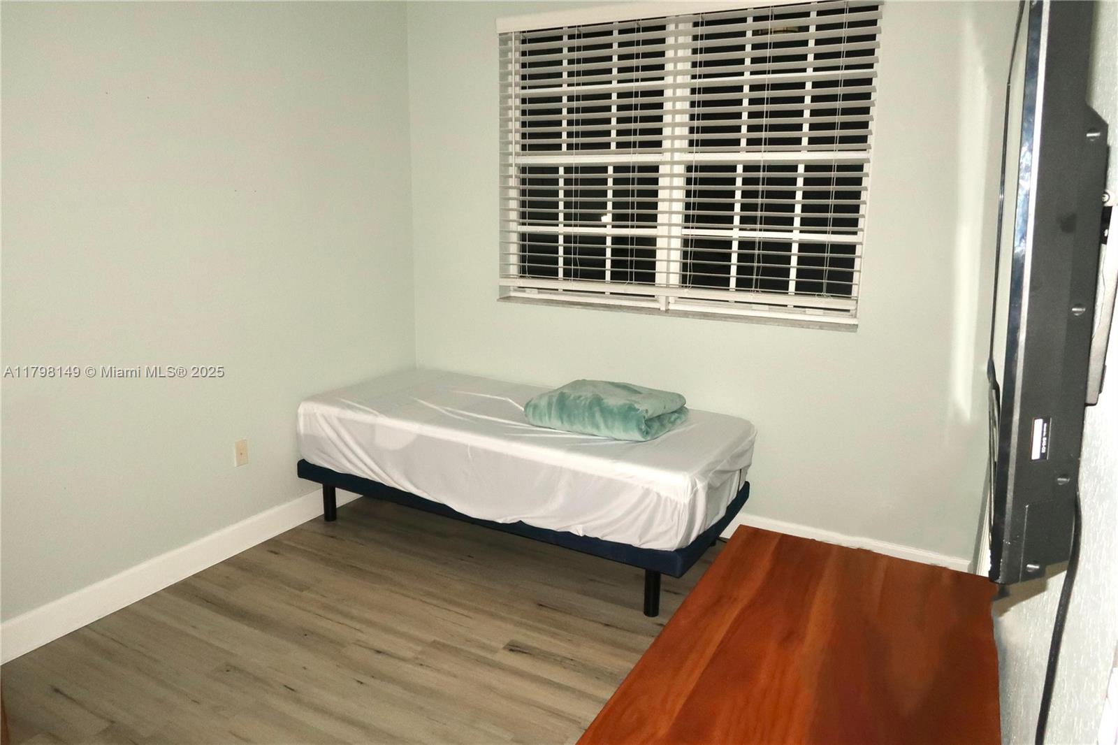 531 Southwest 147th Avenue, Unit 24 Pembroke Pines, FL 33027 - Photo 16 of 16 a bedroom with a bed and a window