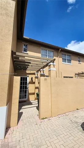 a view of a patio with table and chairs