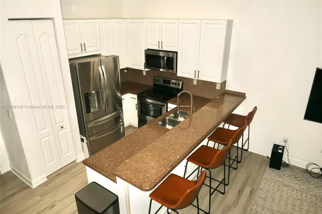 a dining room with furniture and a wooden floor