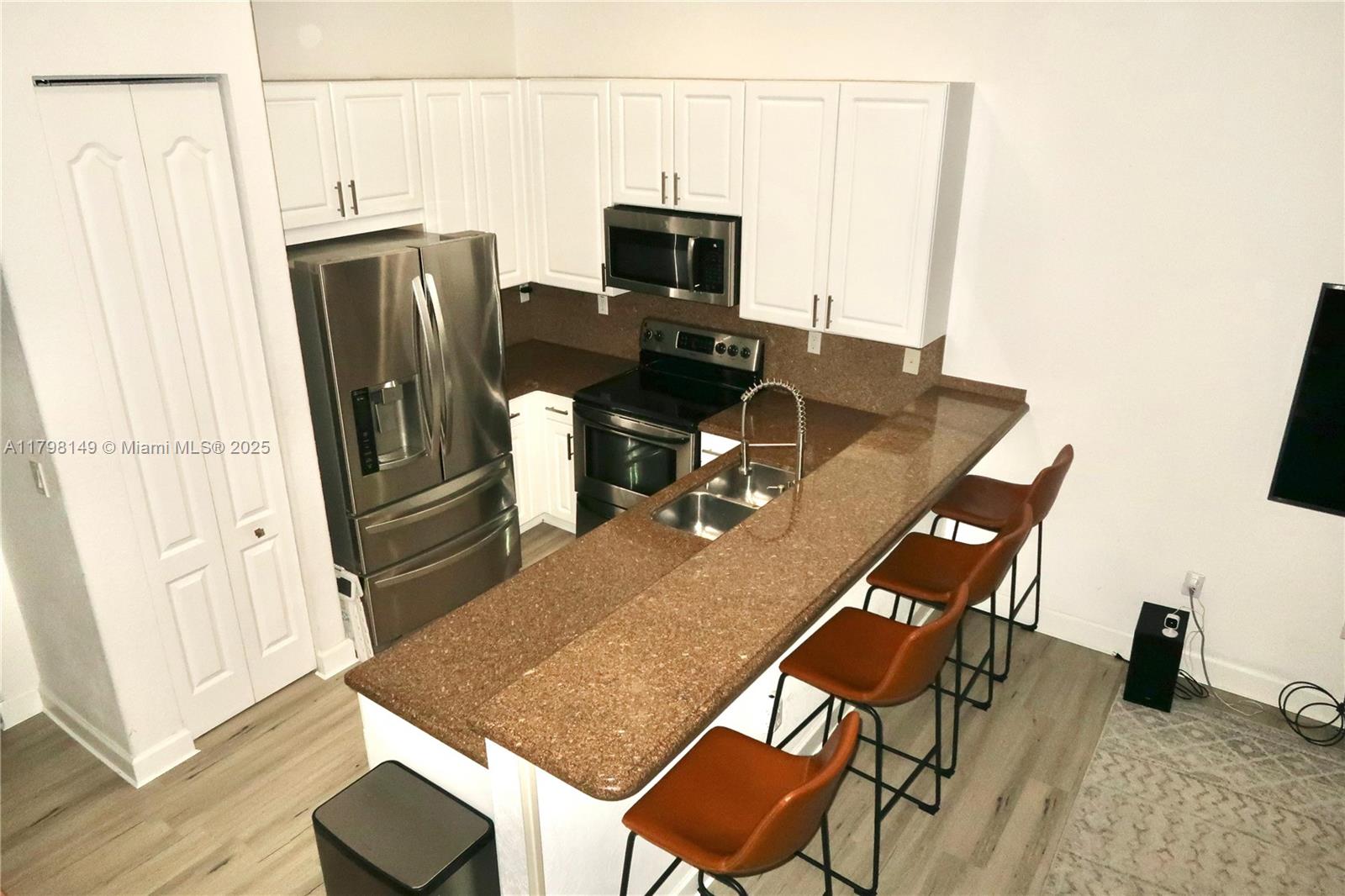 531 Southwest 147th Avenue, Unit 24 Pembroke Pines, FL 33027 - Photo 6 of 16 a dining room with furniture and a wooden floor