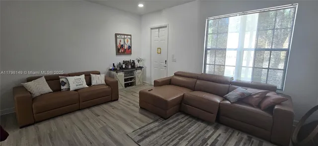 a living room with furniture and a window