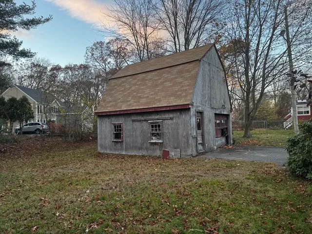 a front view of house with yard and trees