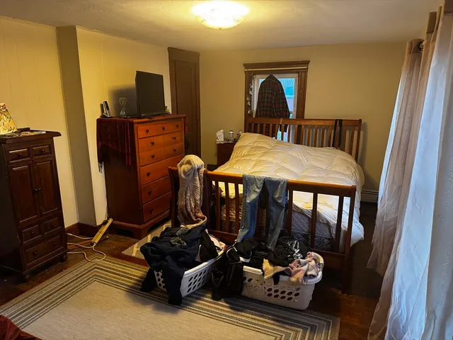 a bedroom with furniture and flat screen tv