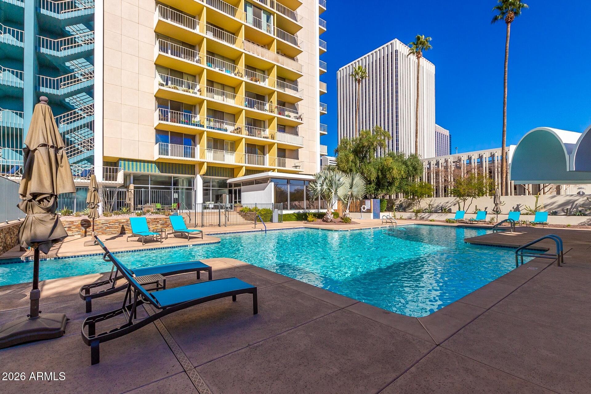 207 West Clarendon Avenue, Unit B2 Phoenix, AZ 85013 - Photo 25 of 30 a swimming pool with outdoor seating and outdoor seating